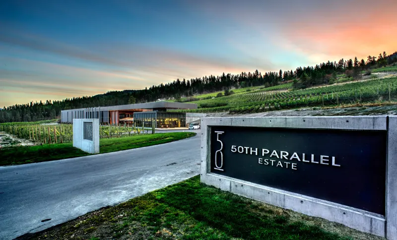 The 50th Parallel Estate entrance sign at sunset